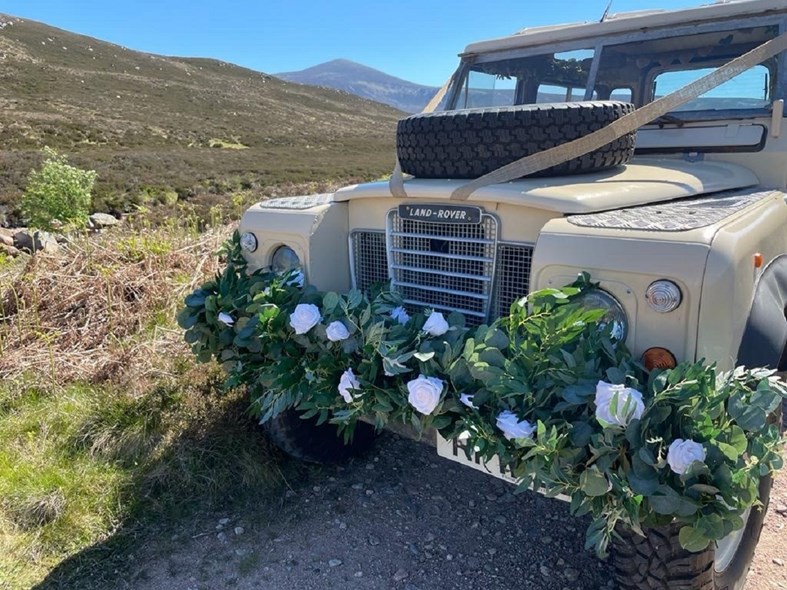 A vintage Land Rover decorated for a wedding from the Scottish business Bonnets and Boots